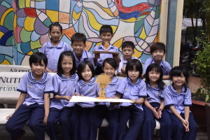 Some Sunshine school children with an Origamo card in Vietnam as part of the company’s commitment to the CNFC charity.