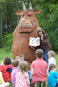 Author Julia Donaldson enthralling children with one of the Gruffalo sculptures that were installed in UK forests.