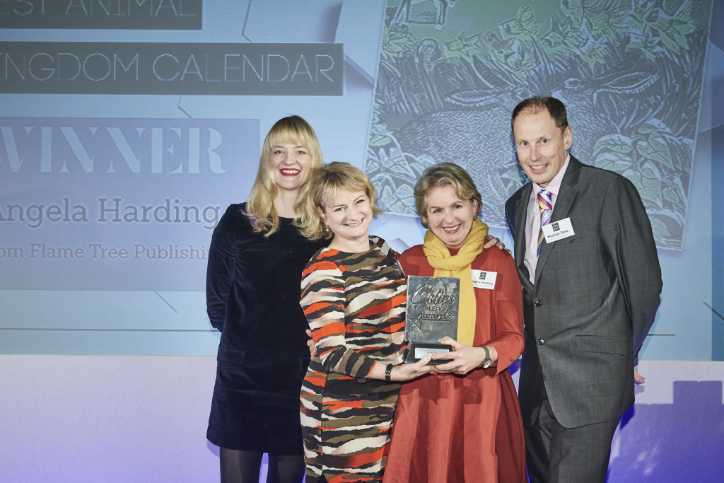 Rose Calendars’ md Michael Rose presented the trophy to Flame Tree Publishing’s managing director Frances Bodiam (2nd left) and renowned printmaker artist Angela Harding.