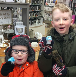 Two Feathering Your Nest young customers with their free penguin kisses bath bomb!