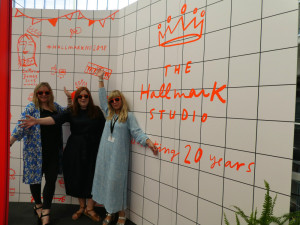 Hallmarkers (left-right) Amy Banks, Laura Broadley and Bibi Klamer on the Hallmark Studio stand at New Designers each wearing some of the free neon sunglasses that were a hit with the students.