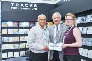 Retailer Chandra Kahn (left) of Just Write redeeming his Silver Ticket on the Tracks’ stand with the publisher’s co-founder Clive Field and national accounts/export manager Debbie Hare.