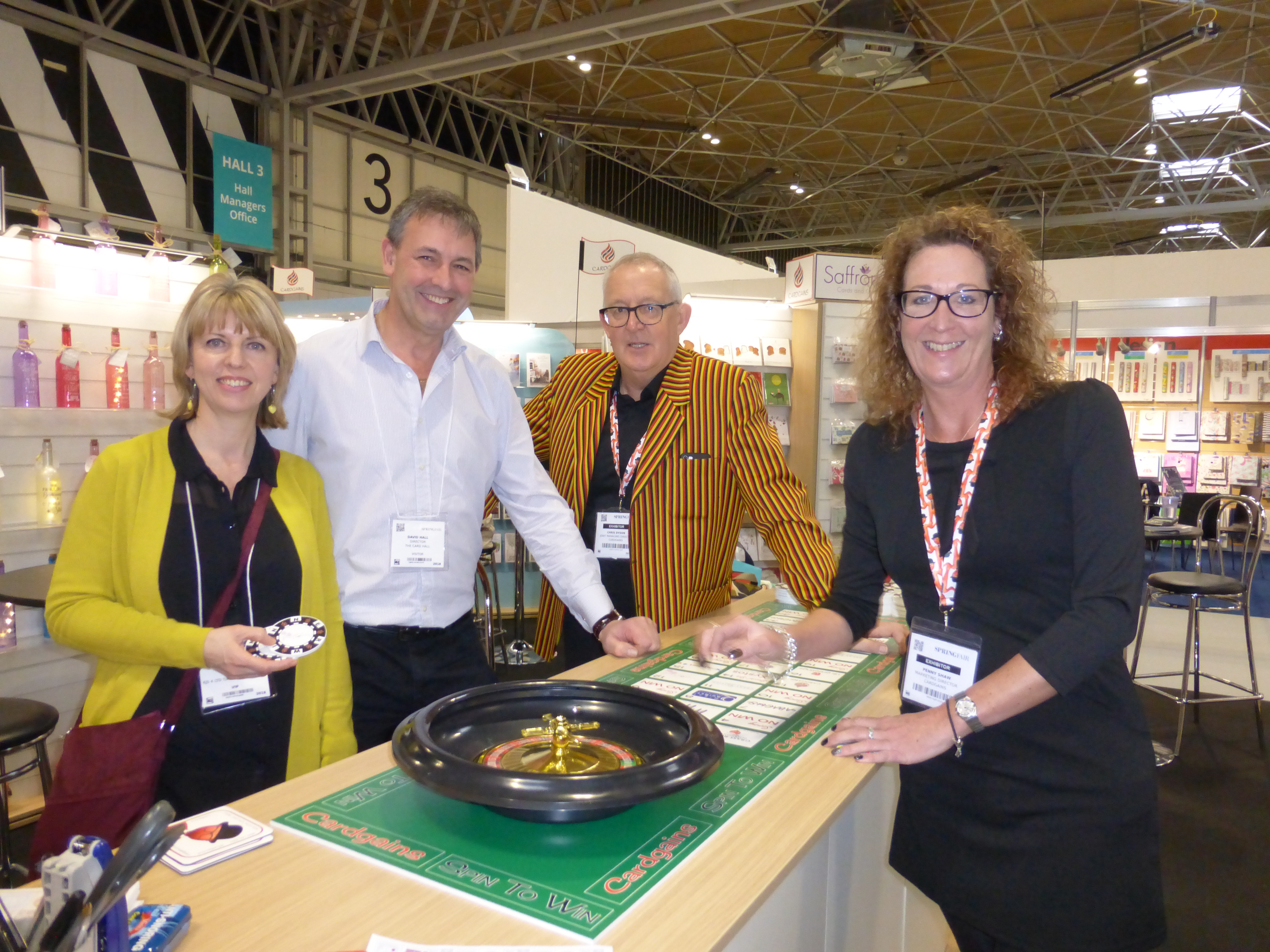 Above: Cardgains’ marketing director Penny Shaw (right) with joint md Chris Dyson (second right) on the buying group’s stand at Spring Fair with members David and Kate Hall (of The Card Hall) participating in its ‘win win’ roulette promo. 