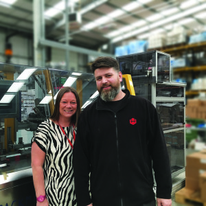 Above: Windles’ business development and marketing manager, Michelle Mills with Greg Parzniewski, packaging manager in front of the machine that has been built to affix the Kard Klasp.