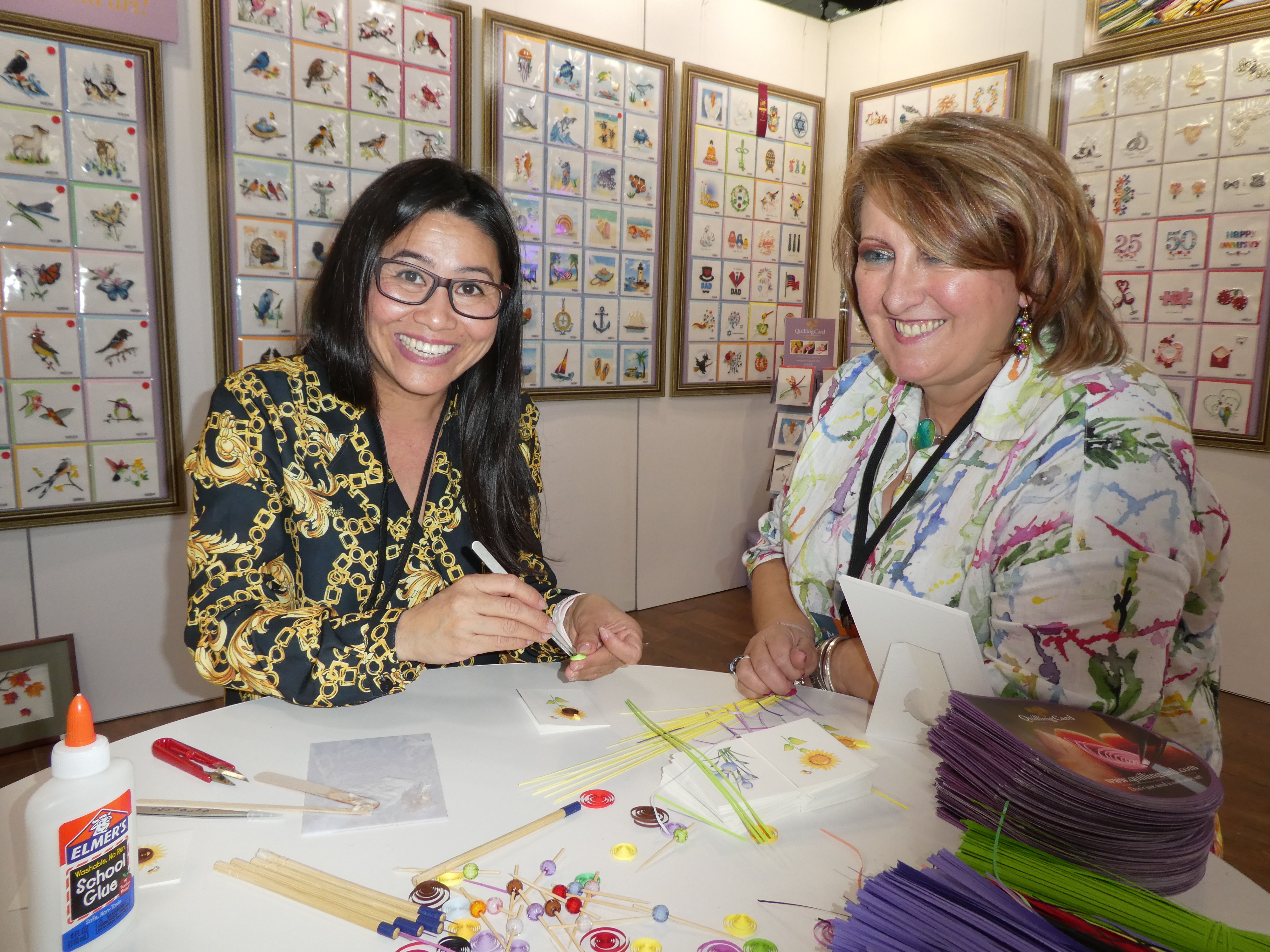 Above: Huong Wolf, founder of Quilling Card demonstrating the art to Rosie Trow, south west agent on its stand at Noted. 