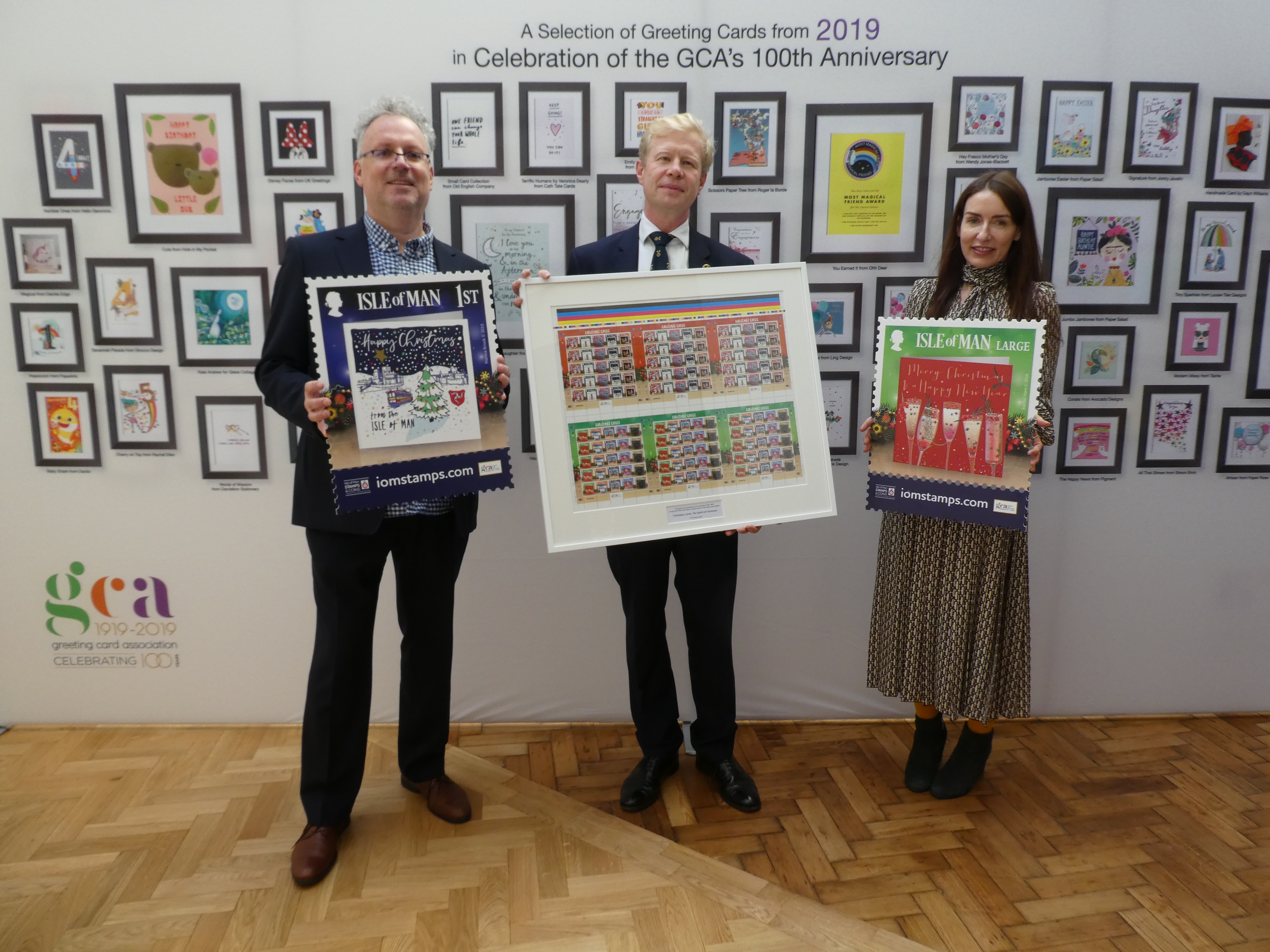 Above: In support of the GCA’s centenary, the Isle of Man Post Office is dedicating this year’s Christmas stamp collection to greeting card art, submitted by GCA publisher members. On behalf of the isle’s Post Office, Ben Glazier, md of Glazier Design presented the GCA with a valuable commemorative set of the stamps, accepted by Rachel Hare, GCA president (and donator of one of the designs) and Geoff Sanderson (of Celebration Nation who co-ordinated the stamp project on behalf of the GCA and Isle of Man Post Office).   