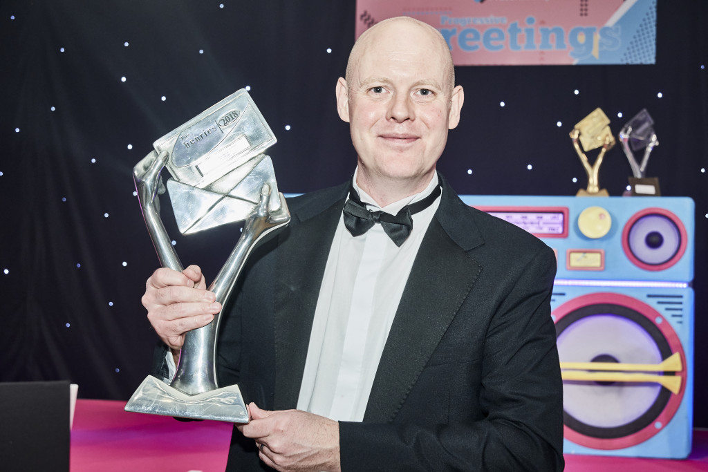 Above: Darren Cave, commercial director of UKG (with a Henries trophy for service) has been keen to protect the safety of the team while resuming the card merchandising services to its grocer customers.