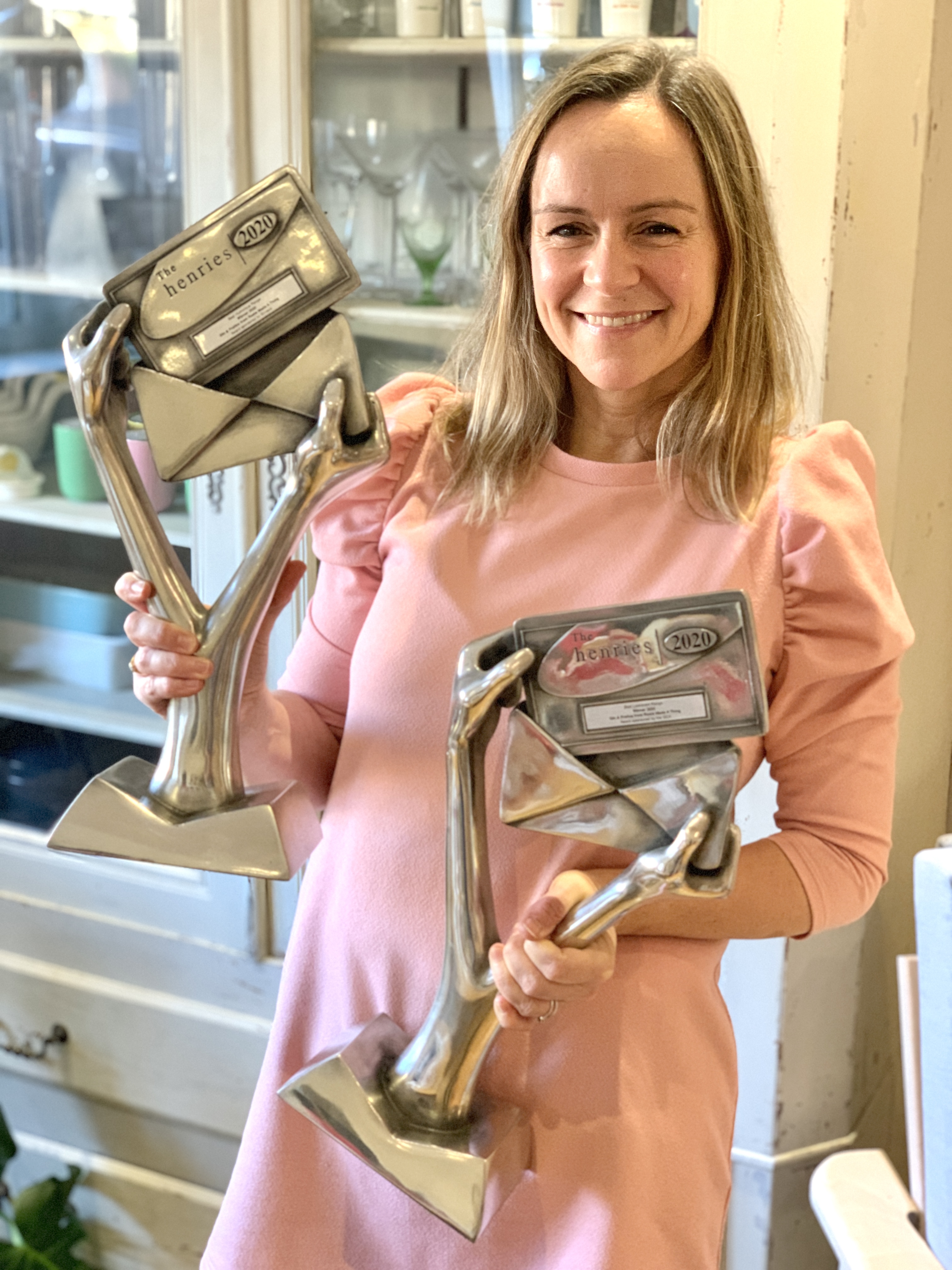 Above: Rosie Harrison, founder of Rosie Made a Thing with her two trophies