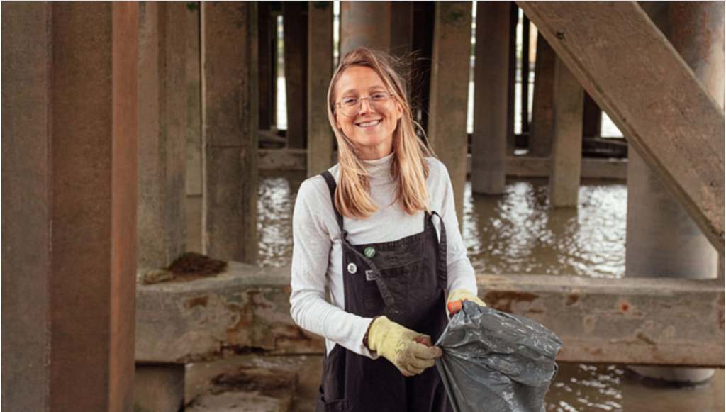 Above: Flora Blathwayt on a river clean, repurposing plastic waste on her card designs.