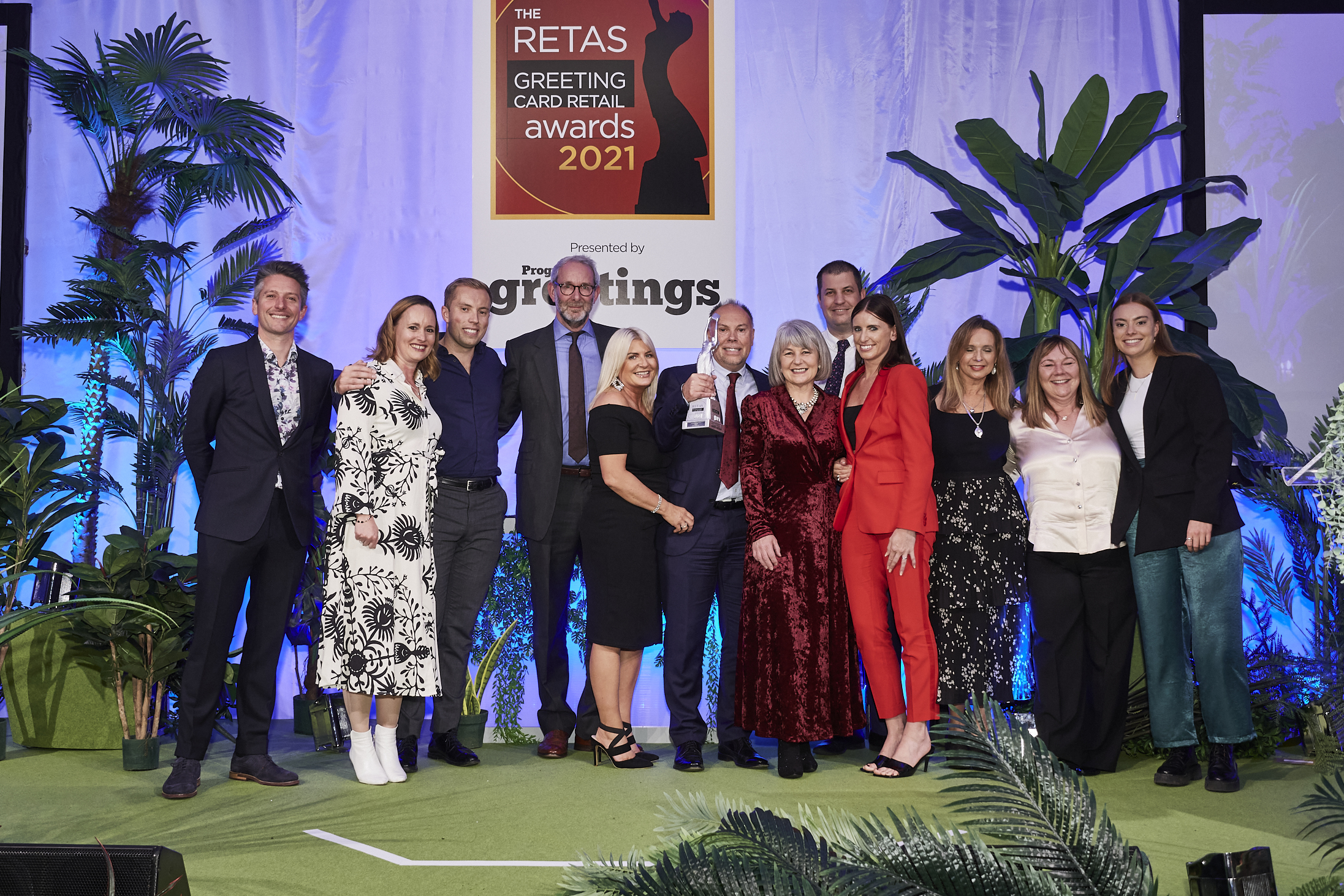 Above: The Cardzone team took to the stage to accept the top trophy from (fourth left) Ged Mace, md of The Art File, sponsor of this award category.