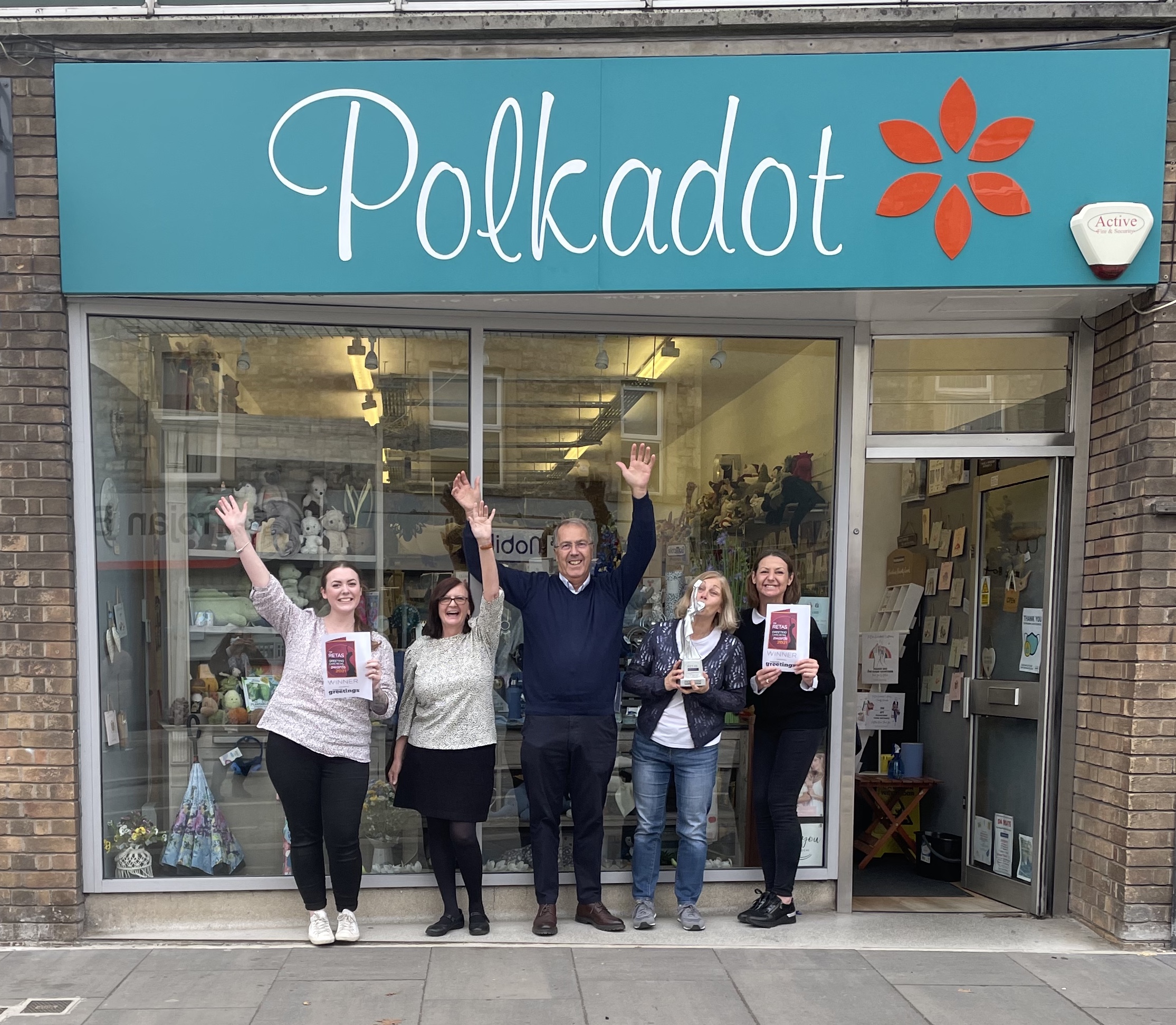 Above: Chris Bryant and The Retas trophy with some of the team outside the Polkadot shop in Keynsham.