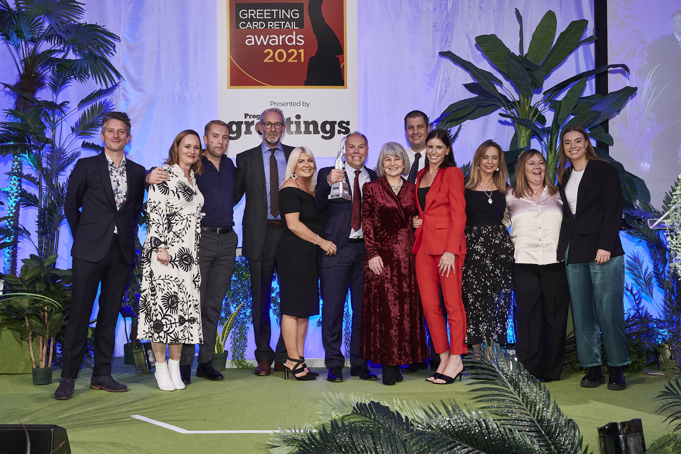 Above: Paul Taylor holding The Retas trophy for Greeting Card Retailer of the Year 2021, on stage at the Grosvenor House Hotel with members of the retail team.