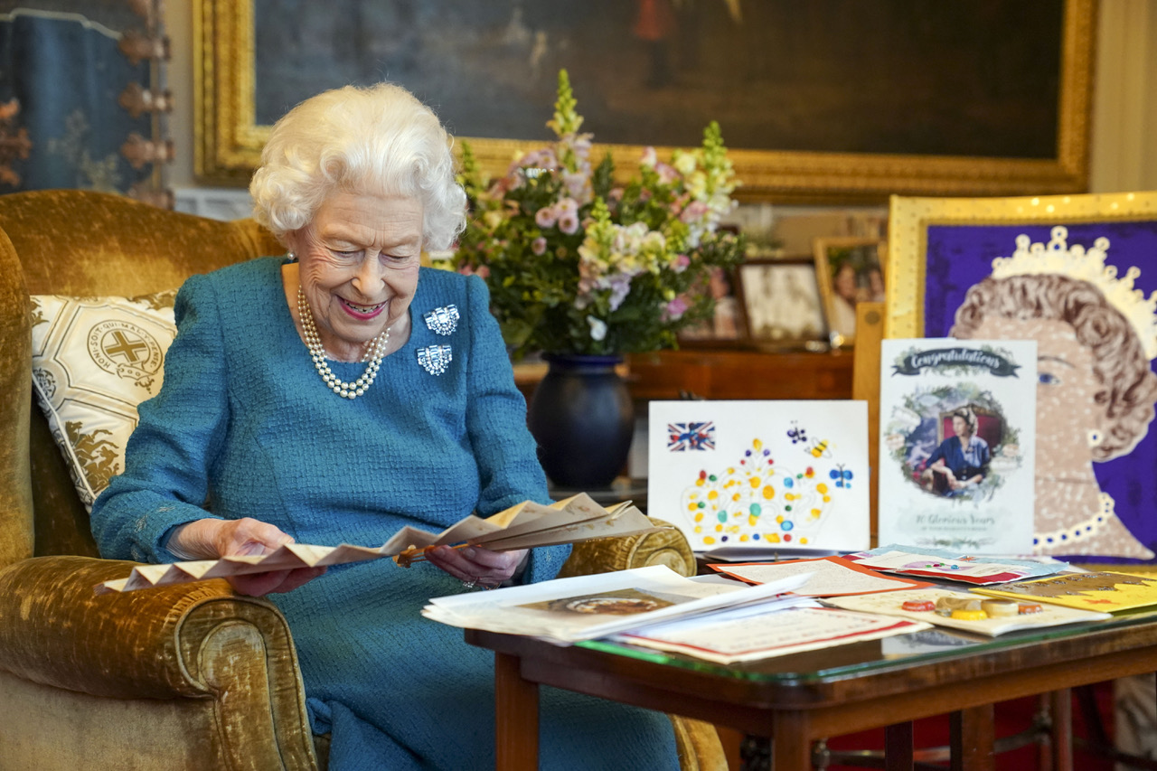 Above: The Queen reading some of her first Platinum Jubilee greeting cards