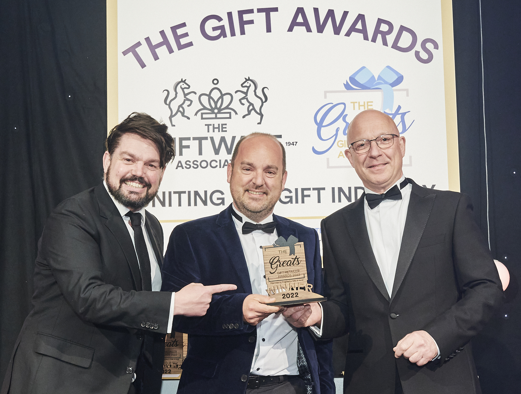 Above: Phil Verrills (right), sales director of category sponsor Gift Republic, presented the Greats trophy to Greg Rose, co-owner of Maybugs, with comedian and compere Charlie Baker (left)