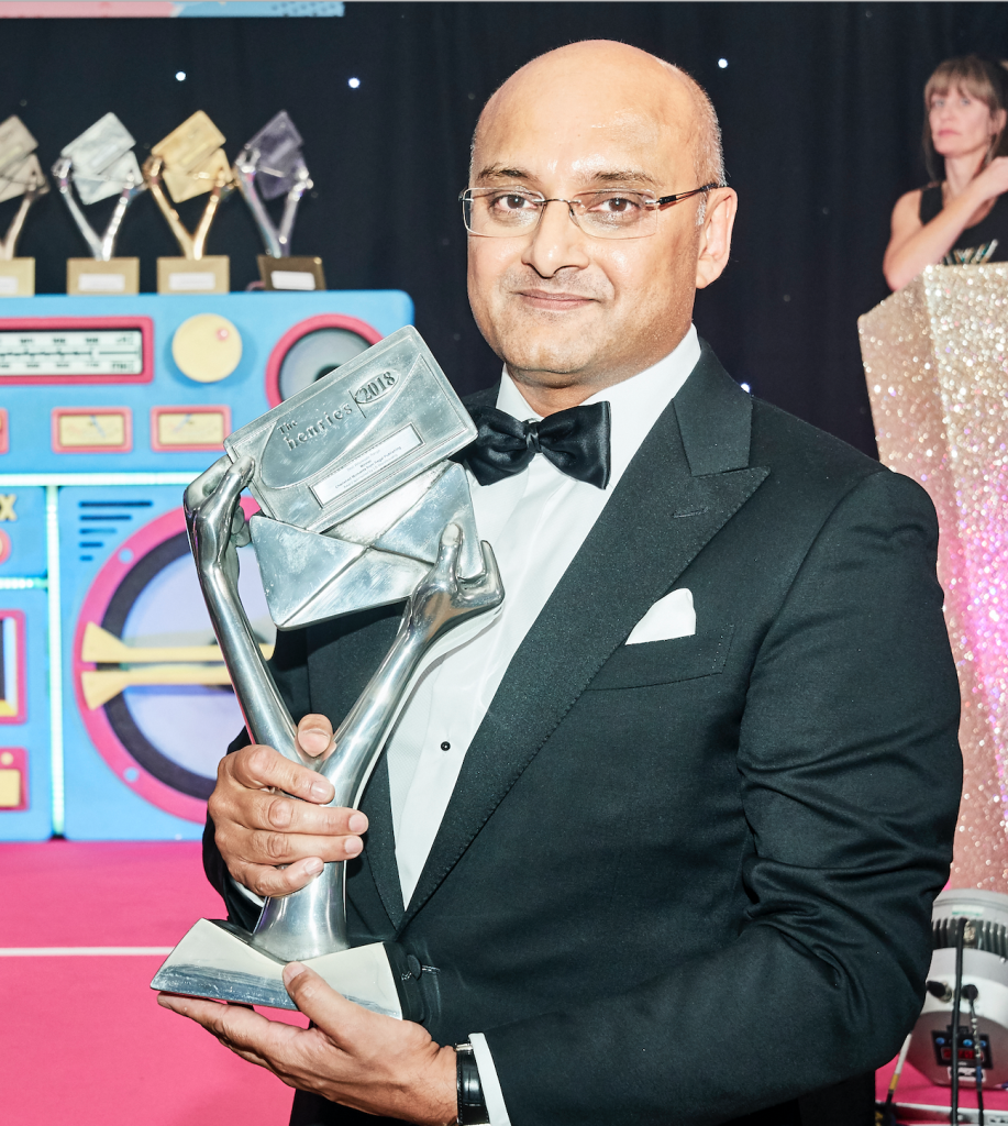 Above: Jitesh Kaneria at The Henries 2018 with the trophy won by his wholesale publishing company Regal Greetings