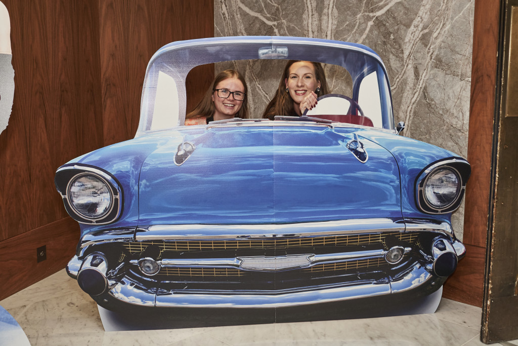Above: John Lewis’ Claire Taylor (right) and Emily Lewis took a spin in the 1950s motor that was ‘parked’ in the reception foyer.