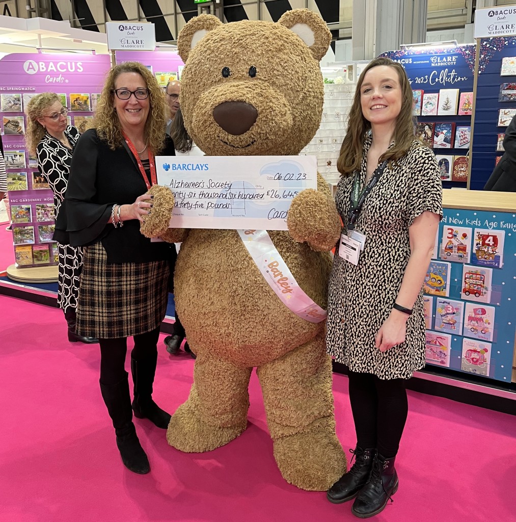 Above: Cardgains’ Penny Shaw (left) and IC&G’s Barley Bear hand over the 2022 cheque at Spring Fair to the Alzheimer’s charity