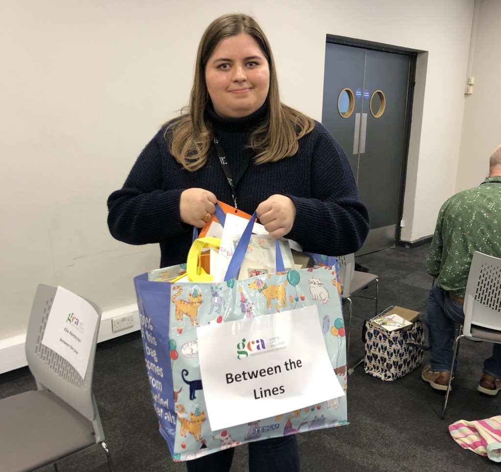 Above: Between The Lines’ Ellie Kleinlercher with a bulging bag of card samples from each of the participating publishers