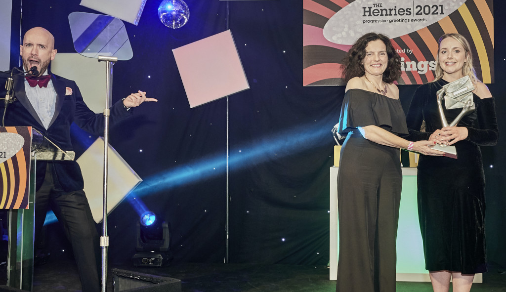 Above: Charlotte collecting the Most Promising Young Designer 2021 award from Postmark’s Leona Janson-Smith as Henries host Tom Allen looks on